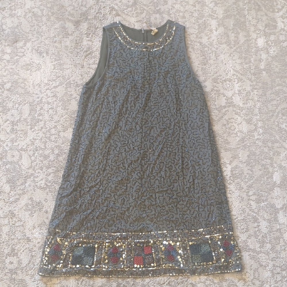 Elegant Green Sleeveless Dress with Embellished Hem